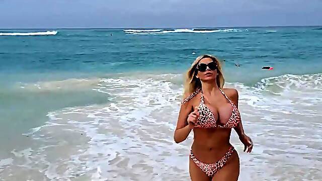 Busty babe playing with her big boobs