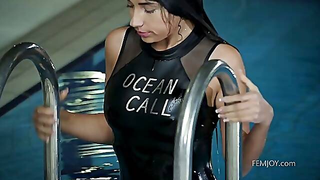 Hot brunette is posing in a black swimsuit and slowly getting naked, to spice it up